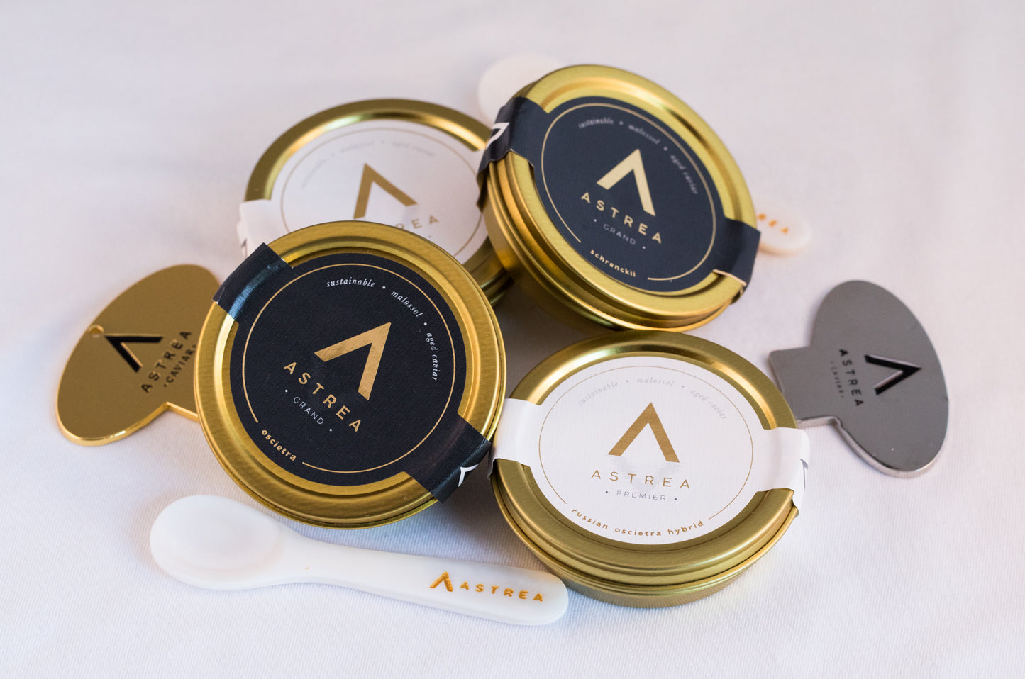 four tins of caviar stacked on top of each other